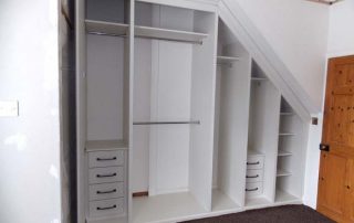 inside a beautiful white and mirrored door, custom fitted wardrobe in a loft conversion