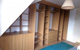 fitted wardrobe in a loft conversion in a cherry finish without doors