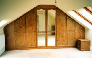 knotty pine wardrobe with hinged doors custom fitted into a sutton coldfield home