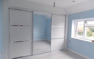 white panelled mirrored sliding wardrobe door with aluminium framework